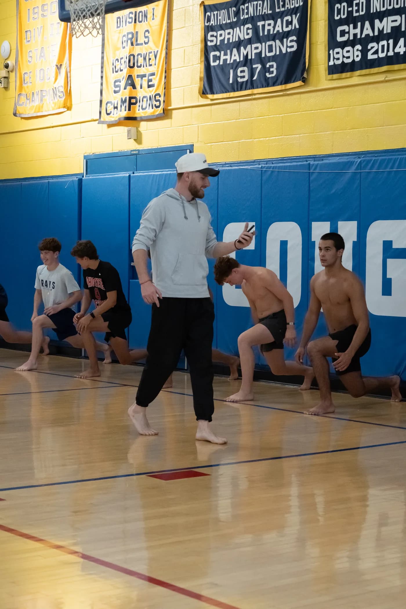 Steven Giardina walking the line while the group works through split squats